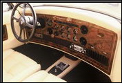 This 1987 Clenet Series II shows the luxurious interior features such as inlaid walnut burl and Waterford crystal ashtray.