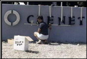 John DiMora using his skills beyond sales to hang the company name on the front of the new building.